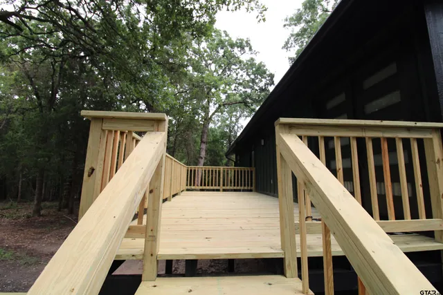 a view of balcony with wooden floor and fence