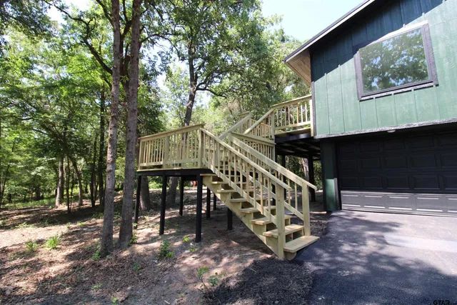 a view of house with outdoor space and deck