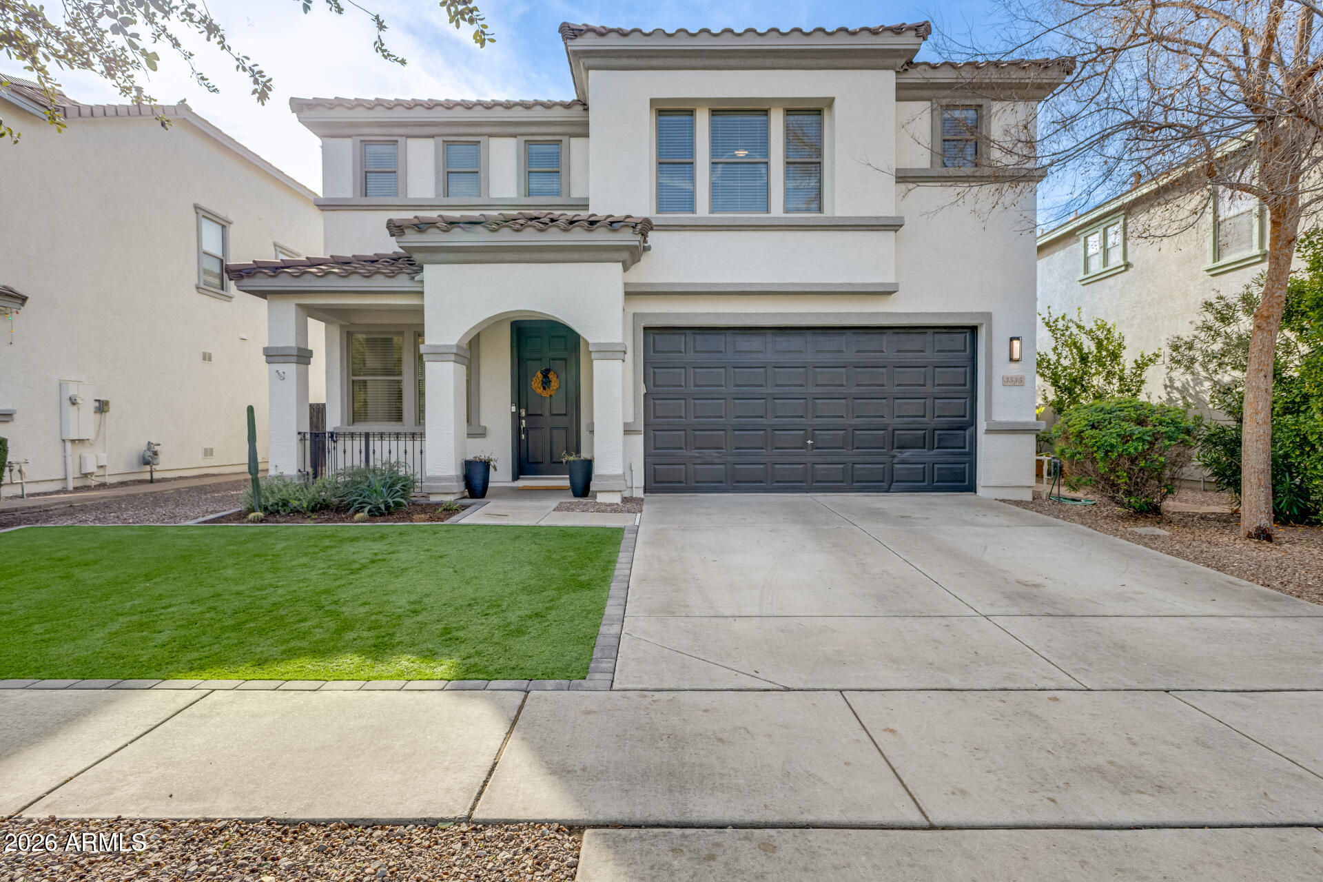 a view of a white house with a yard and plants