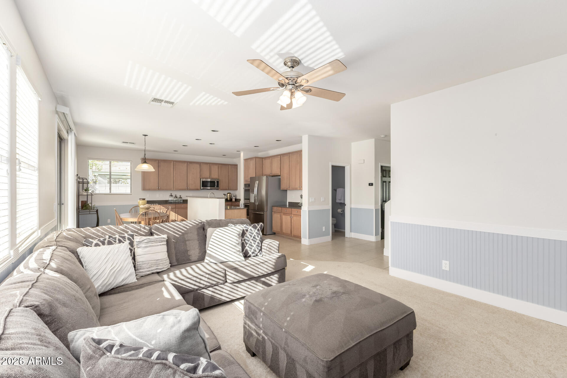 3535 East Terrace Avenue Gilbert, AZ 85234 - Photo 11 of 56 a living room with furniture white walls and chandelier