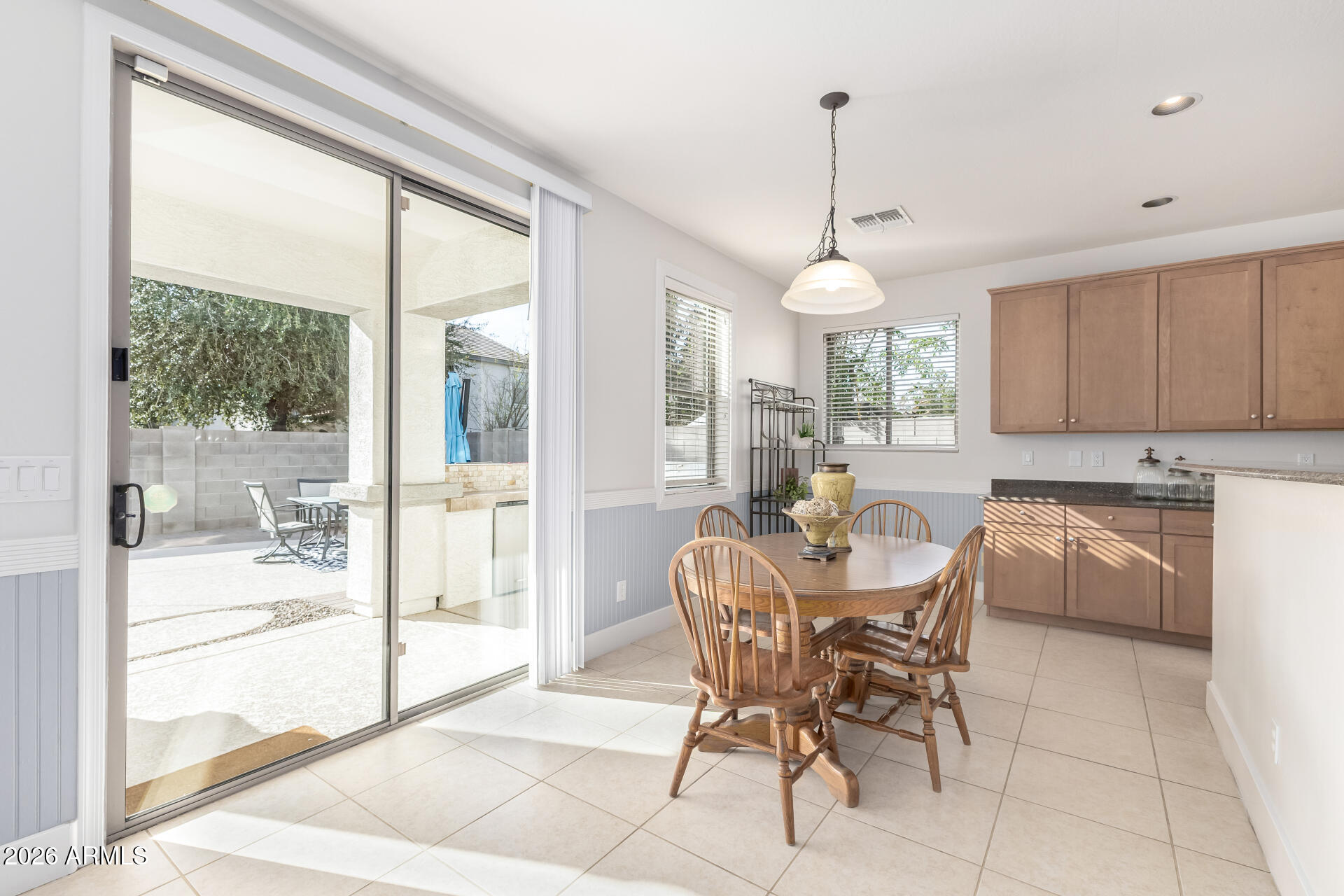 3535 East Terrace Avenue Gilbert, AZ 85234 - Photo 16 of 56 a dining room with furniture a chandelier and window
