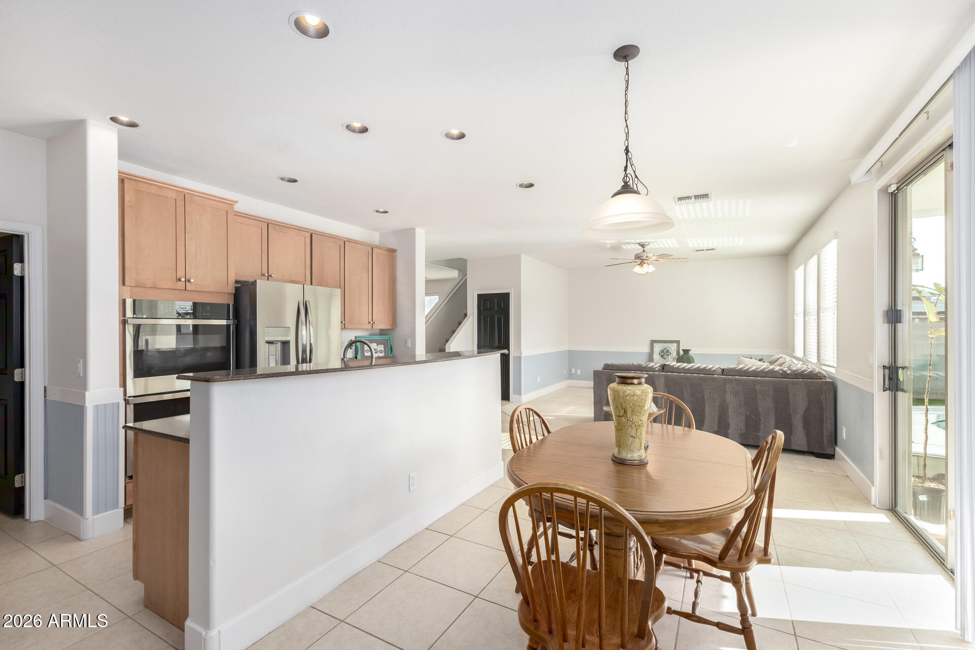 3535 East Terrace Avenue Gilbert, AZ 85234 - Photo 17 of 56 a view of a dining room and livingroom with furniture wooden floor a chandelier