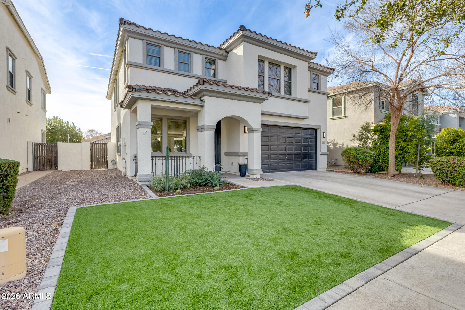 3535 East Terrace Avenue Gilbert, AZ 85234 - Photo 2 of 56 a front view of a house with a garden and yard