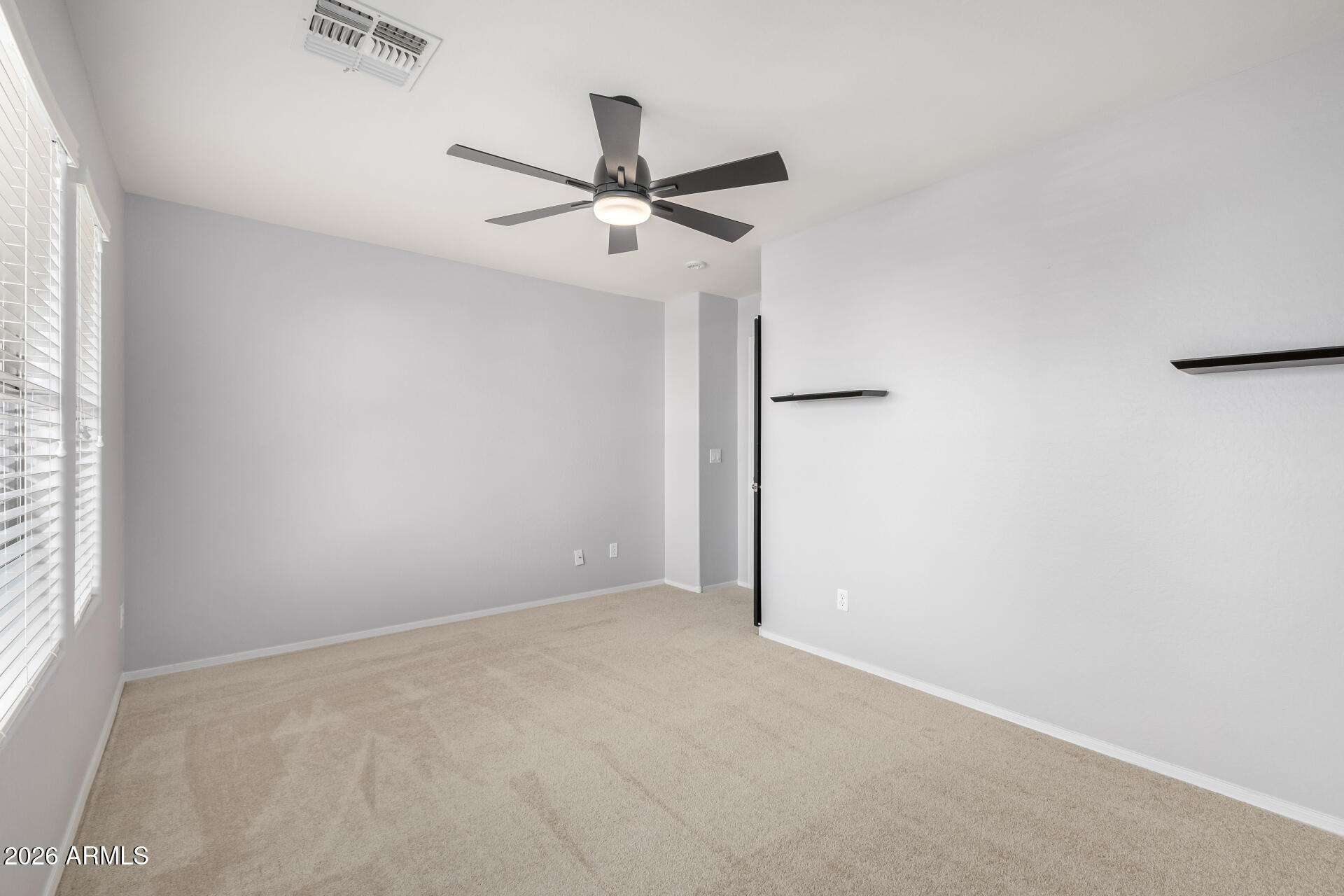 3535 East Terrace Avenue Gilbert, AZ 85234 - Photo 34 of 56 an empty room with windows and fan