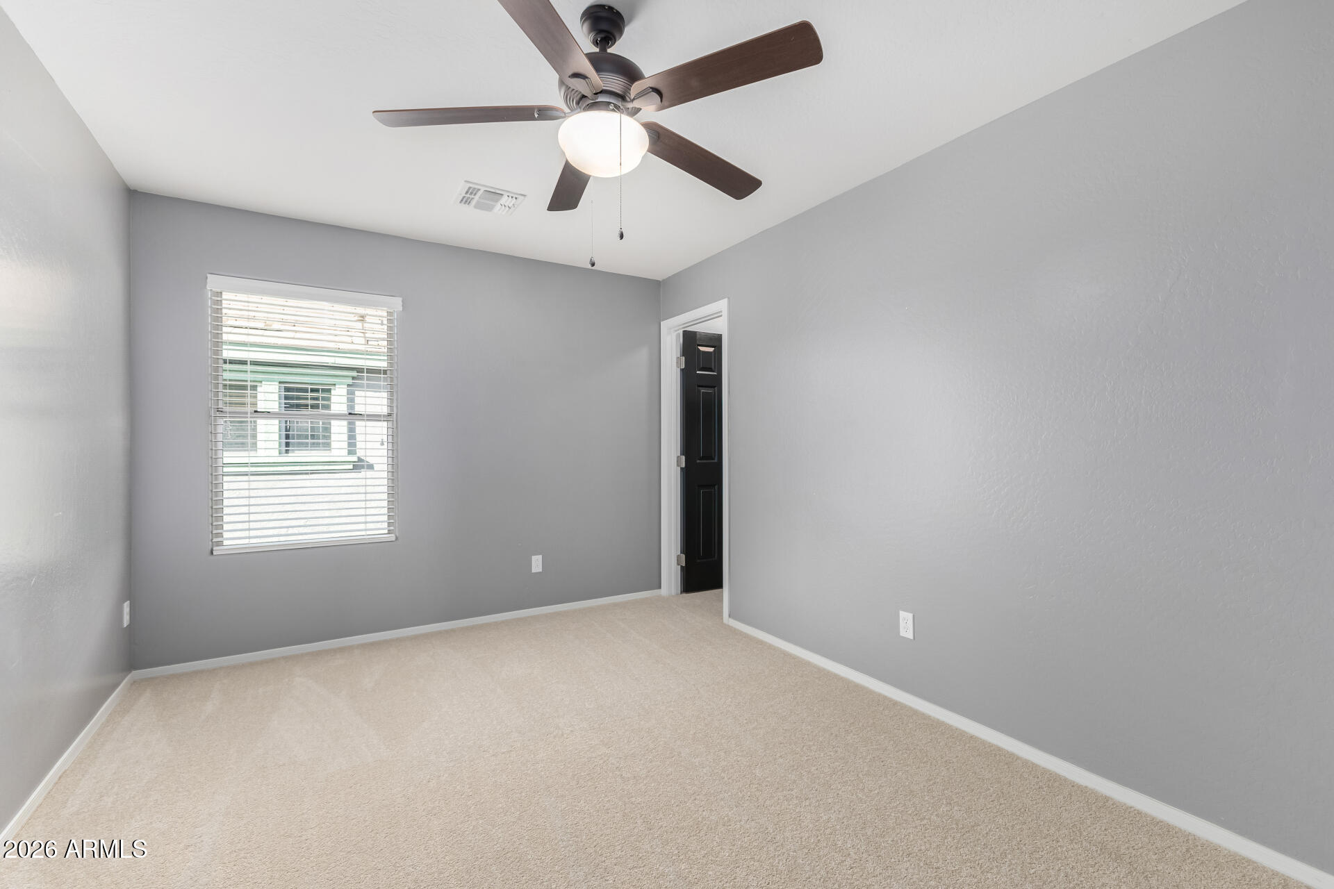 3535 East Terrace Avenue Gilbert, AZ 85234 - Photo 39 of 56 an empty room with a window and a fan