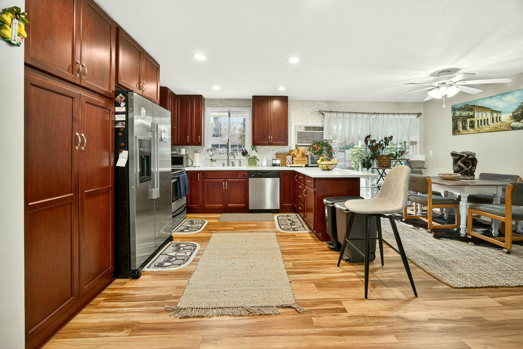 659 Herman Avenue Medford, OR 97501 - Photo 21 of 42 a kitchen with stainless steel appliances kitchen island granite countertop a refrigerator dining table and chairs
