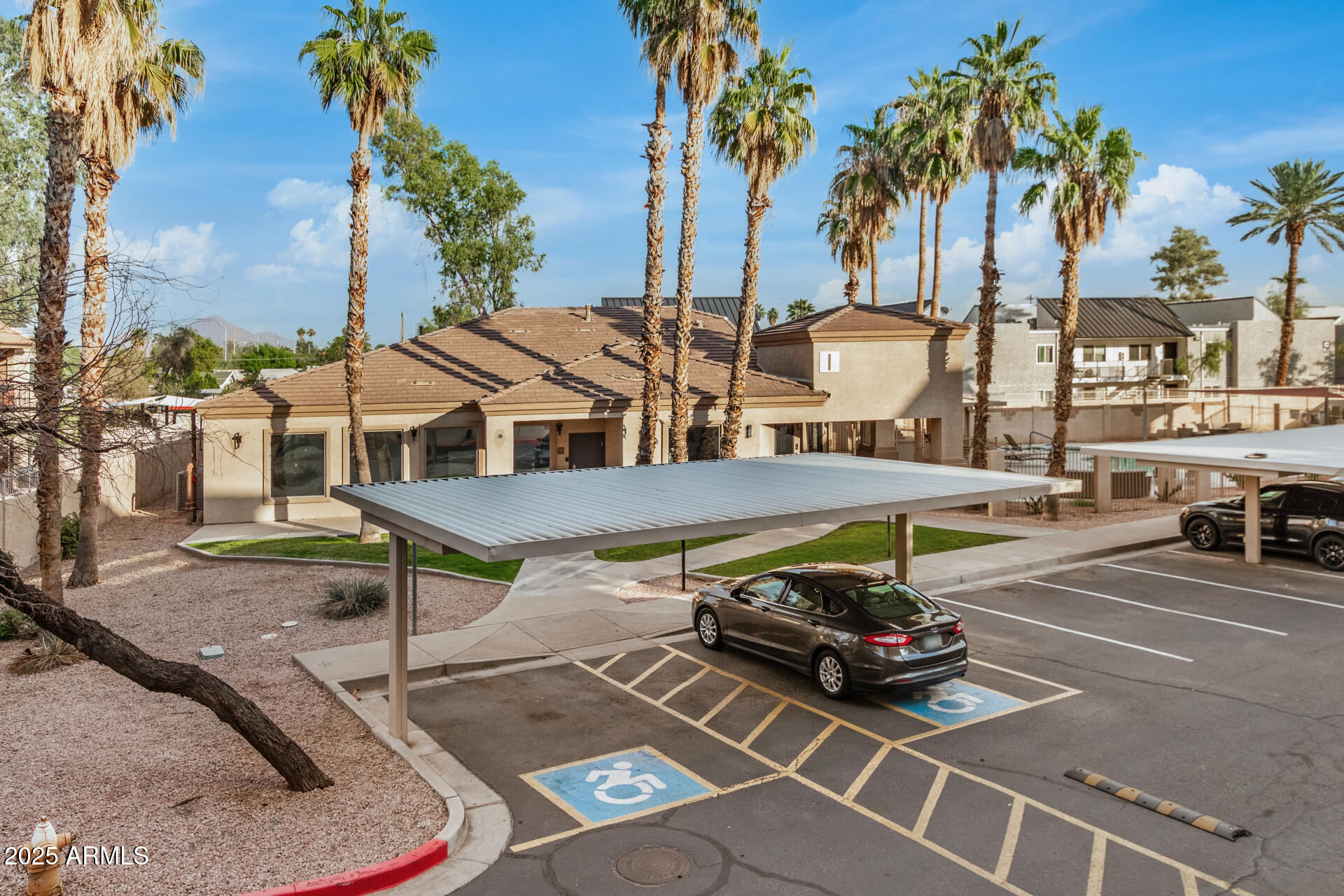 920 East Devonshire Avenue, Unit 2020 Phoenix, AZ 85014 - Photo 28 of 37 a view of a patio with table and chairs potted plants and palm trees