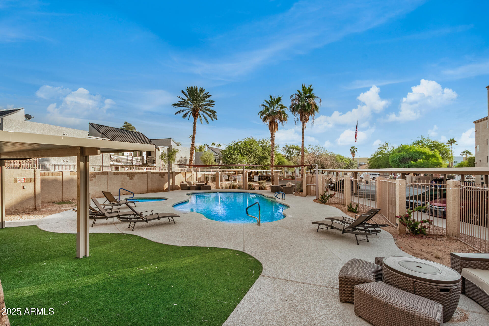 920 East Devonshire Avenue, Unit 2020 Phoenix, AZ 85014 - Photo 30 of 37 a view of a swimming pool with lounge chairs