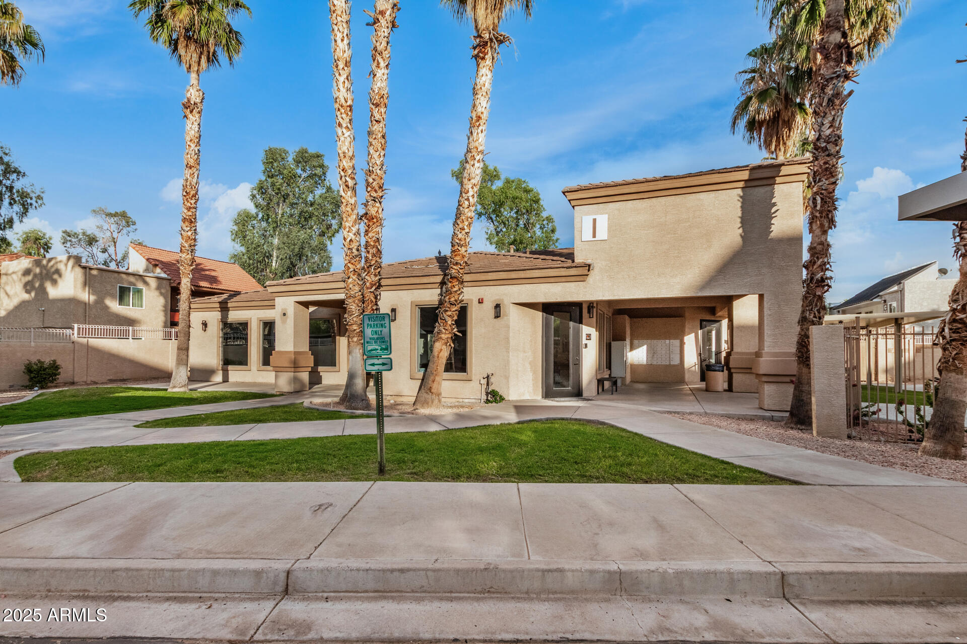 920 East Devonshire Avenue, Unit 2020 Phoenix, AZ 85014 - Photo 32 of 37 a view of a brick house with a yard next to a road