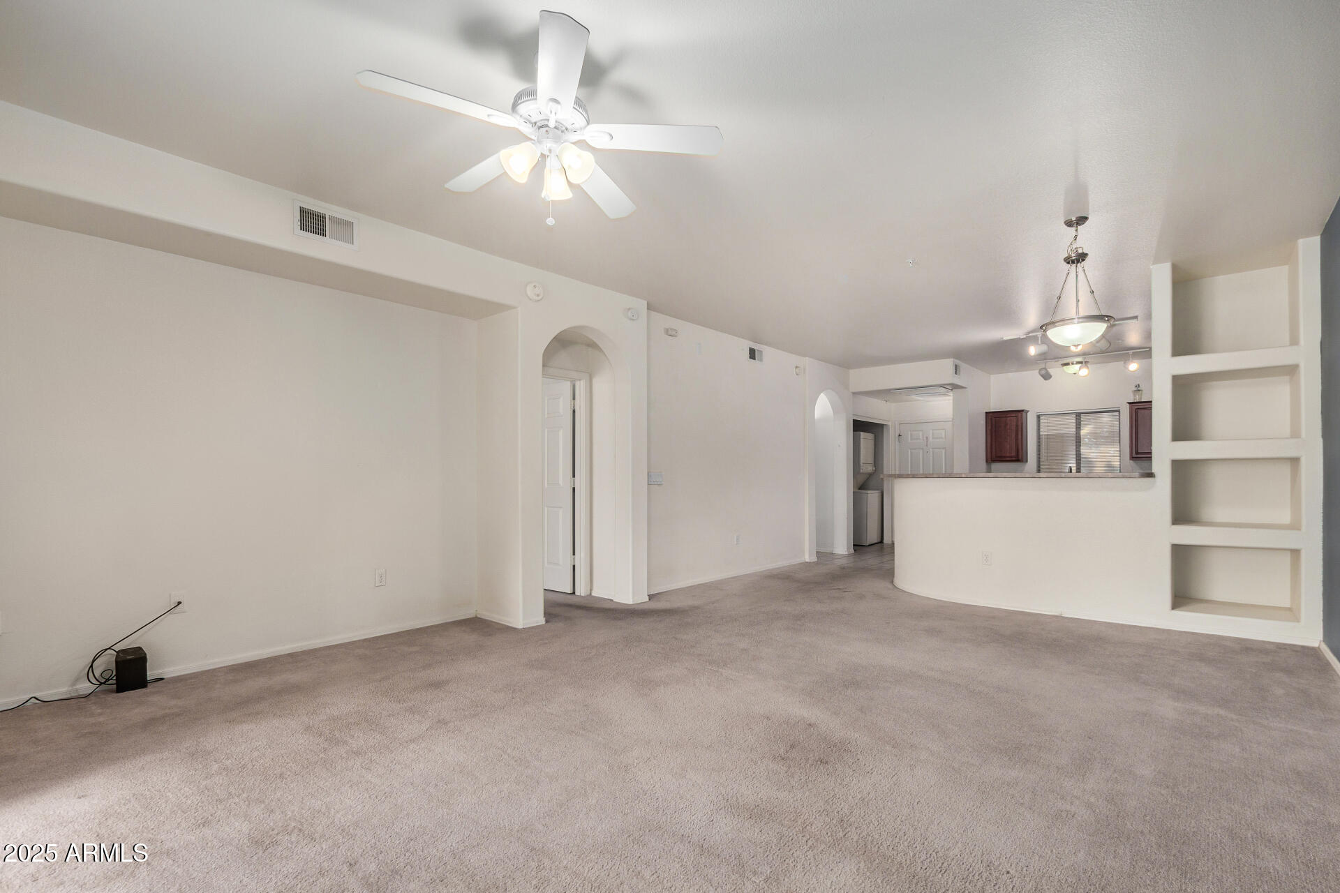 920 East Devonshire Avenue, Unit 2020 Phoenix, AZ 85014 - Photo 8 of 37 en empty room with windows and ceiling fan