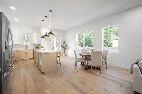 a kitchen with stainless steel appliances granite countertop a sink a stove and a window