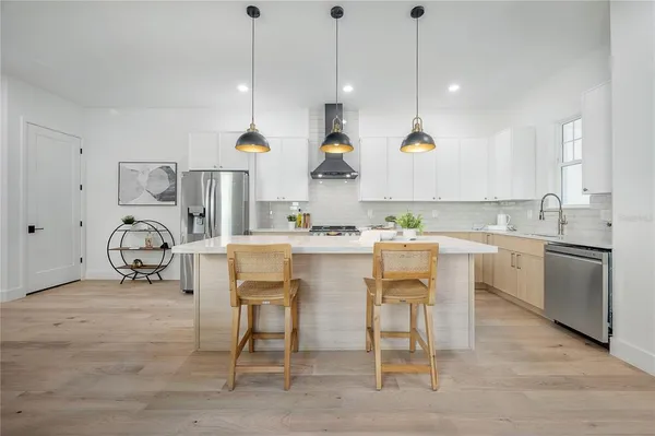 a kitchen with appliances cabinets and a sink