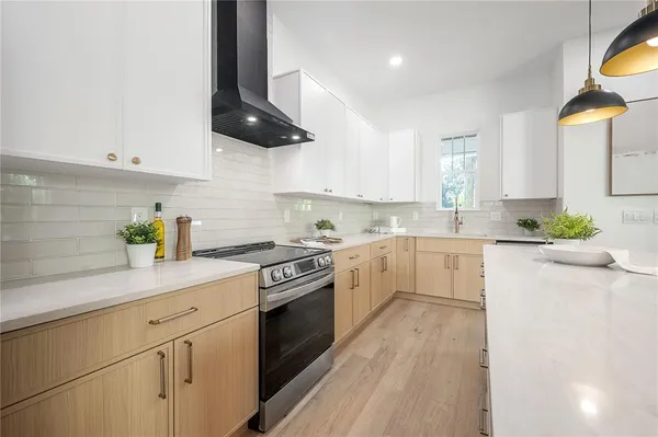 a kitchen with stainless steel appliances white cabinets and a sink