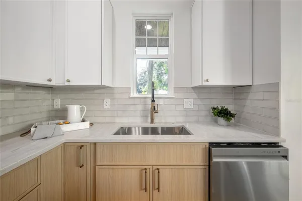 a kitchen with sink stove and wooden floor