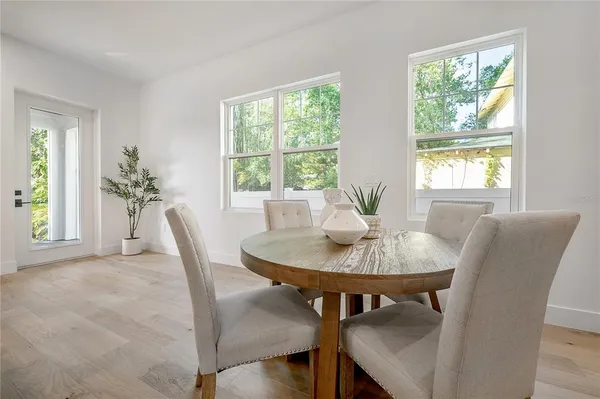 a kitchen with a refrigerator and white cabinets