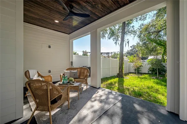 a view of a hallway with wooden floor and a bathroom