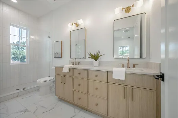 a bathroom with a toilet and shower