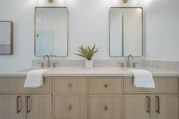 a bathroom with a double vanity sink and a mirror