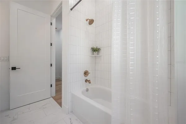a view of a room with wooden floor