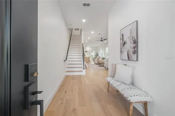a living room with furniture potted plant and a large window