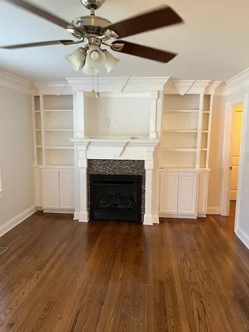 a view of an empty room with a fireplace and a window