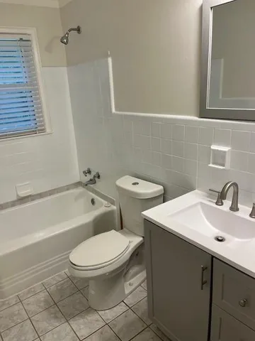 a white toilet sitting next to a bathroom sink