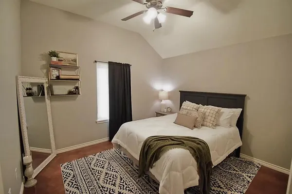 a bedroom with a bed and dresser