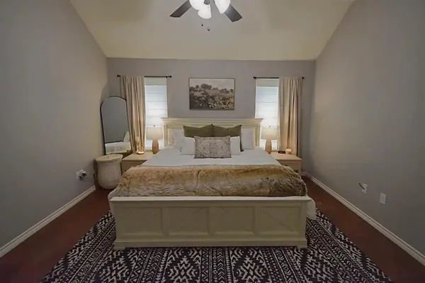 a bedroom with a bed and a chandelier