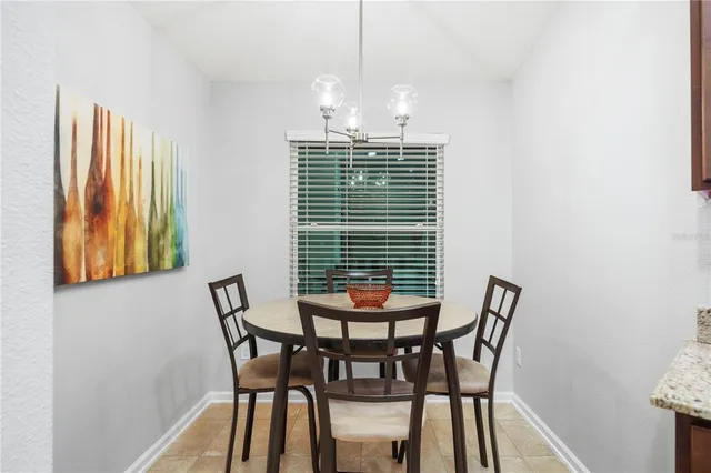 a view of a dining room with furniture and window