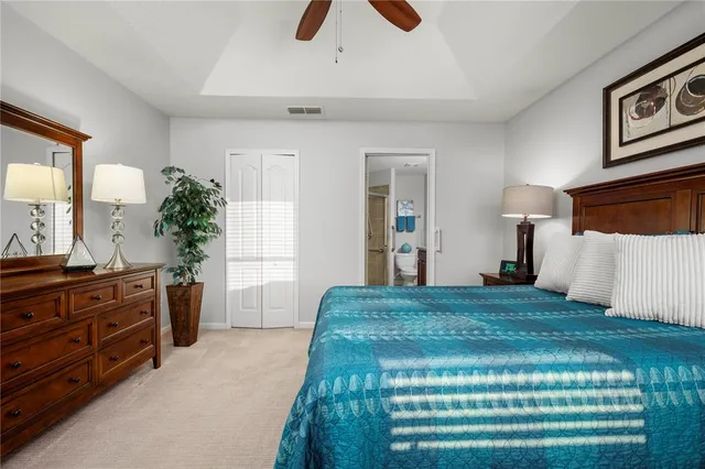 a bedroom with a large bed and a chandelier