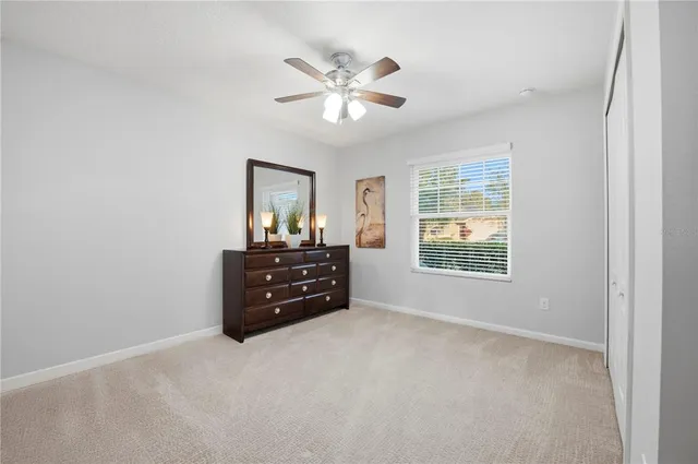 a room with a bed cabinets and a window