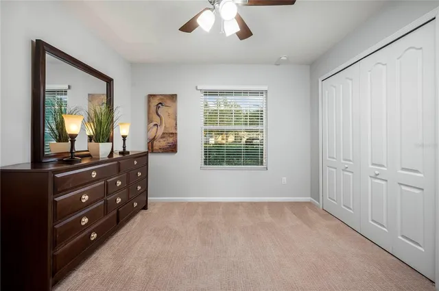 a room with a bed and a mirror on dresser