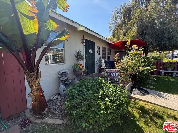 a view of a house with a flower garden