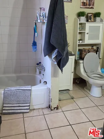 a bathroom with a sink a toilet and bathtub