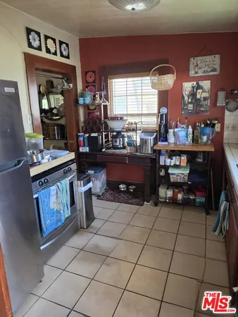 a kitchen with granite countertop a stove a sink and a cabinets