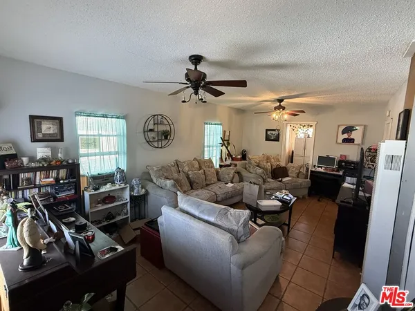 a living room with furniture a chandelier furniture a chandelier and a window