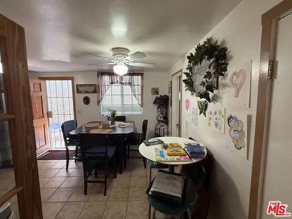 a view of a dining room with furniture and chandelier