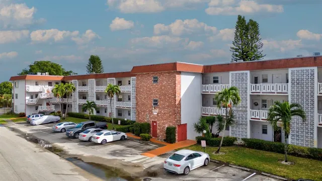 a front view of a house with a yard and outdoor seating