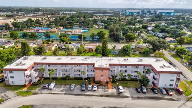 an aerial view of a house with a garden and lake view