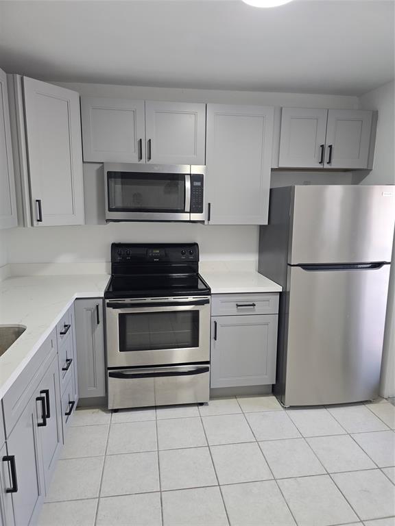 4310 Northwest 12th Court Lauderhill, FL 33313 - Photo 2 of 29 a kitchen with cabinets stainless steel appliances and a counter space