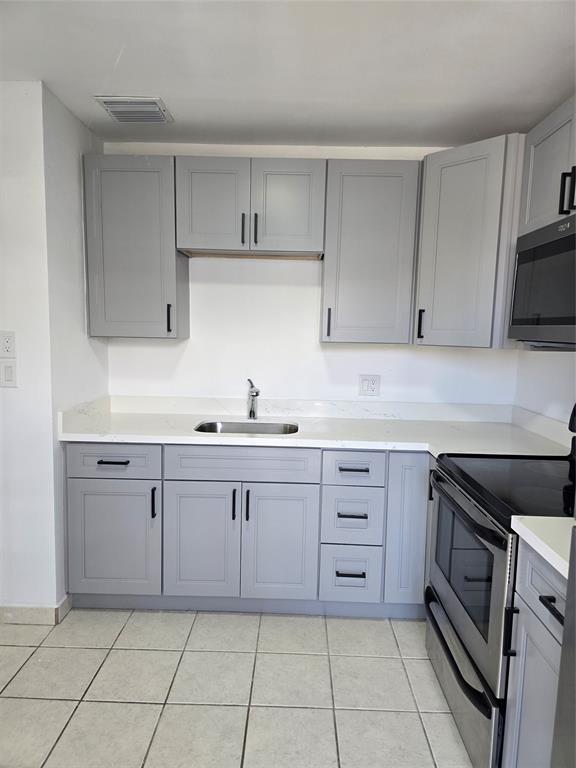 4310 Northwest 12th Court Lauderhill, FL 33313 - Photo 3 of 29 a kitchen with cabinets appliances and a sink