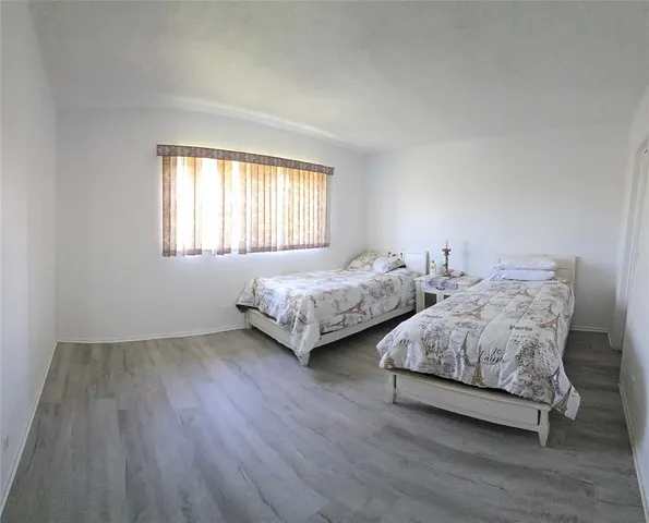 a bedroom with two beds and a night stand