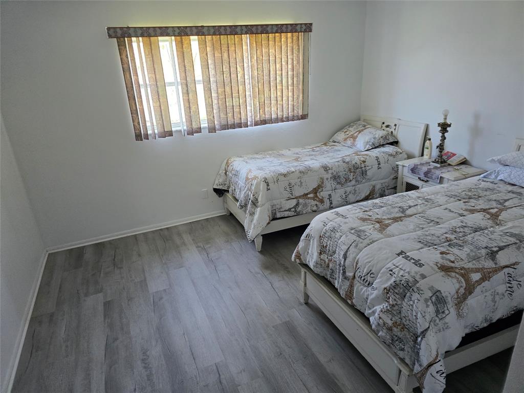 4310 Northwest 12th Court Lauderhill, FL 33313 - Photo 5 of 29 a bedroom with two beds and a window
