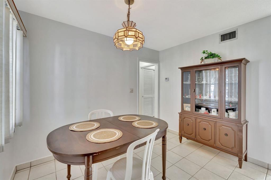4310 Northwest 12th Court Lauderhill, FL 33313 - Photo 9 of 29 a view of a dining room with furniture and chandelier