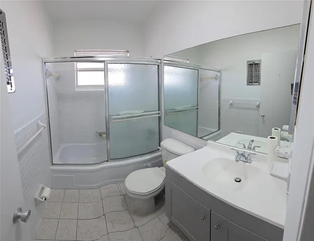 a bathroom with a shower a toilet and sink