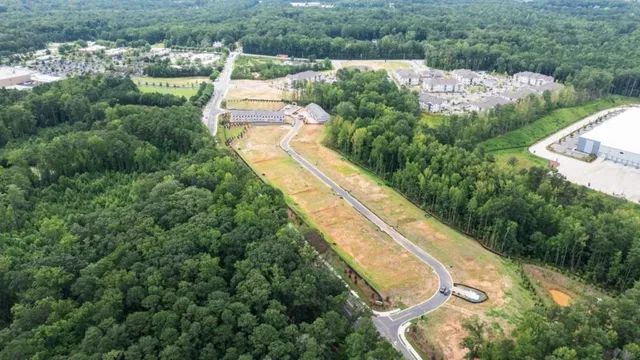 a view of a swimming pool with lawn chairs under an umbrella