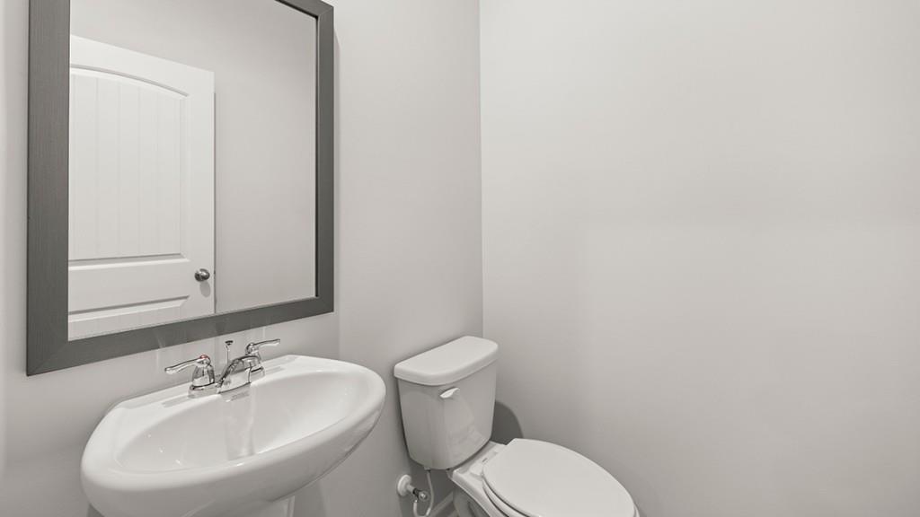 3277 Ryker Road Gainesville, GA 30507 - Photo 14 of 54 a bathroom with a toilet a sink and mirror