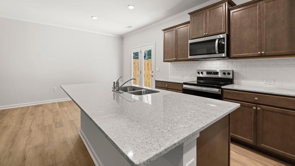 3277 Ryker Road Gainesville, GA 30507 - Photo 4 of 54 a kitchen with stainless steel appliances granite countertop a sink microwave and stove top oven