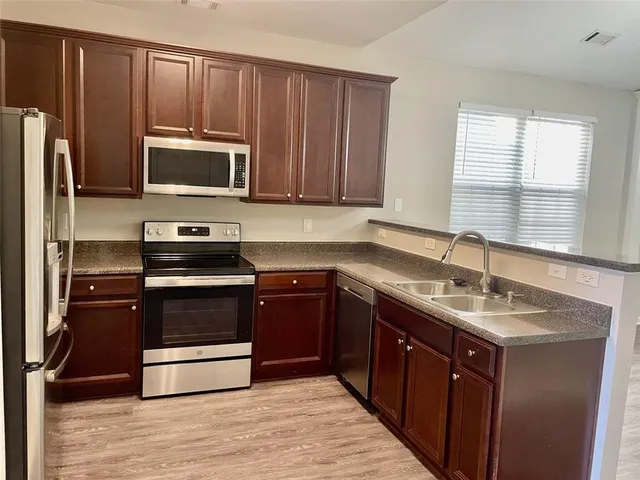 a kitchen with a sink stove and microwave