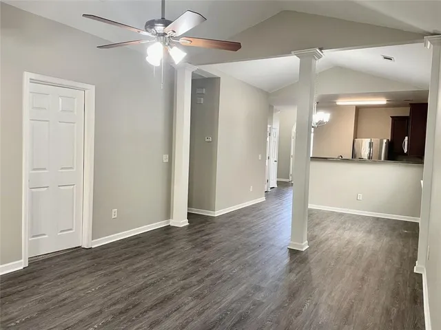 a view of a big room with wooden floor and a ceiling fan